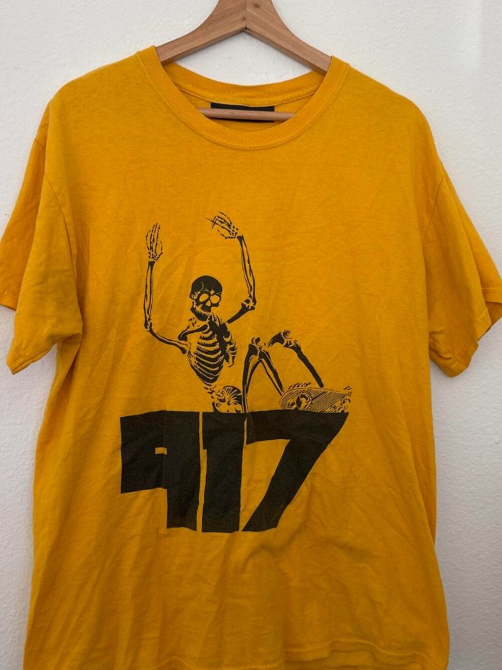 Nine One Seven yellow skeleton tee with black skeleton graphic and '917' text